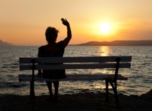Woman on bench and sunset - vacation background